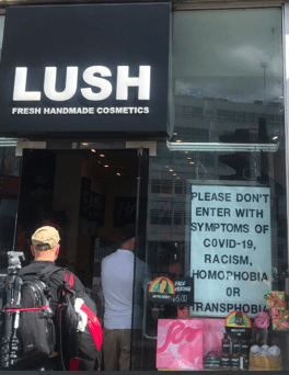 Sign in yet another LUSH store: Please don't enter with symptoms of covid-19, racism, homophobia or transphobia.